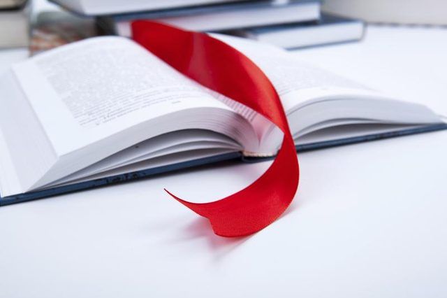 Une marque de livre de ruban rouge dans un livre ouvert.