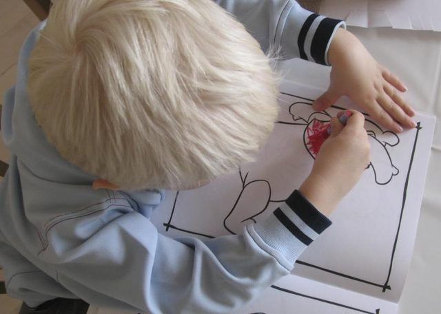 Jeune garçon coloration avec crayon.