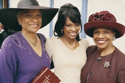 Un groupe de trois femmes souriantes extérieur d'une église